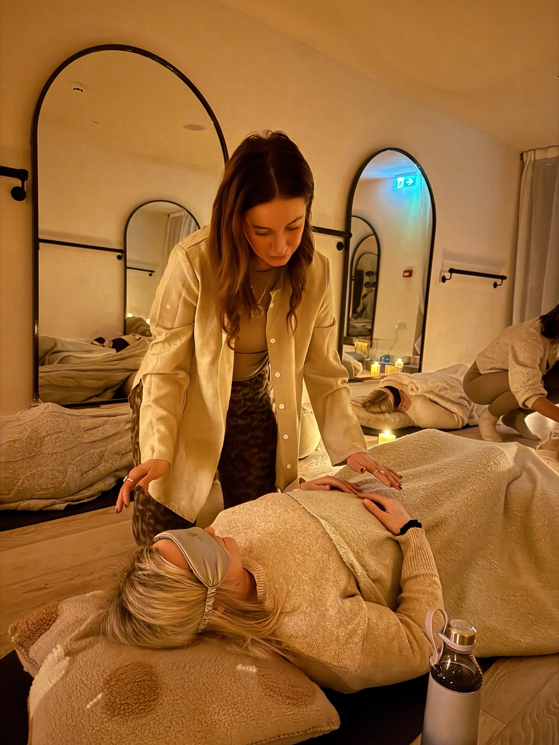 Leanne offering gentle somatic touch to a resting participant